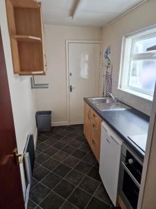 a small kitchen with a sink and a window at Vance House in Blackpool