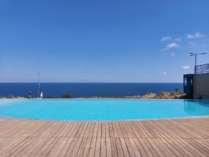 a large swimming pool with the ocean in the background at апартаменты GREENWOOD in Odesa