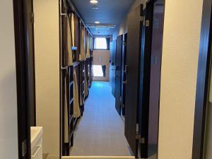 a corridor of a hallway with some doors and a hallway at Higashi Shimbashi Building 3F Hostel Gion SORA - Vacation STAY 92728v in Kyoto
