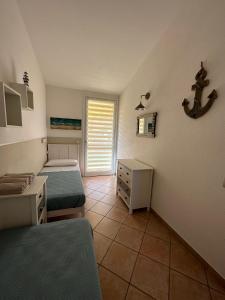 a small room with two beds and a window at Villa Elma in Villaputzu