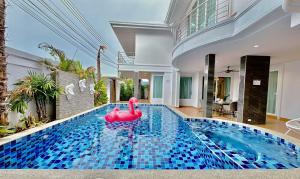 a swimming pool with a pink rubber duck in a house at Turtle's Cove 8 Bedroom Luxurious PoolVilla in Pattaya South
