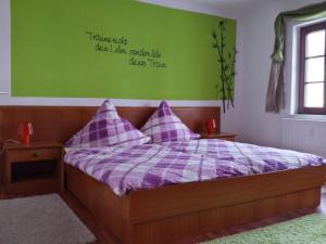 um quarto com uma cama com uma parede verde em 4 JahresZeiten em Meissen