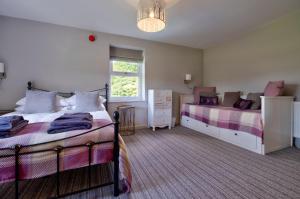 a bedroom with two beds and a window at House - Private use in Sedbergh