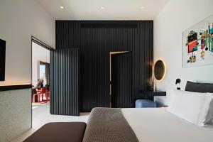 a bedroom with a bed and a black wall at MAP Boutique Hotel in Nicosia