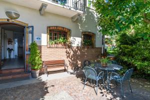a patio with a table and chairs and a bench at La Casa di Baba in Masserano