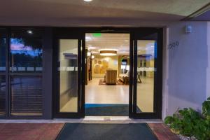 an entrance to a building with glass doors at Holiday Inn Express Fort Lauderdale North - Executive Airport, an IHG Hotel in Fort Lauderdale