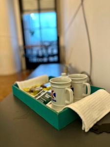 two coffee cups sitting on a tray on a table at Hermoso departamento, en excelente ubicación. in Buenos Aires