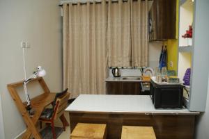 a small kitchen with a table and a sink at EnZ 6 lovely Apartments in Bungoma