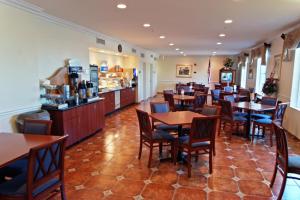 a restaurant with tables and chairs and a counter at Holiday Inn Express Calexico, an IHG Hotel in Calexico