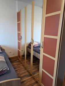 a bedroom with a mirror and a bed in it at Gästehaus Gröpelingen in Bremen