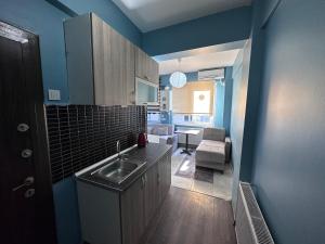 a kitchen with a sink and a living room at STONE HOME Hostel in Istanbul