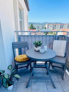 a blue table and two chairs on a balcony at BeeApartments Naściszowska 18 in Nowy Sącz