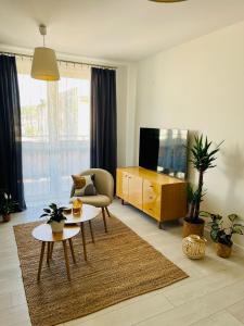 a living room with a tv and a couch and a table at BeeApartments Naściszowska 18 in Nowy Sącz