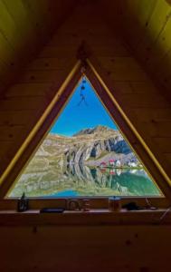 a view of a mountain from a window in a cabin at Kapetanovo Jezero Bungalov in Podgorica