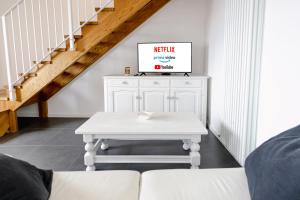 a white coffee table in a living room with a staircase at Trieste 10min dal Centro Villa Privata con Jacuzzi in Trieste