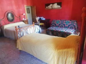 a bedroom with two beds and a chair at La Torre di Pieve in Pieve Santo Stefano