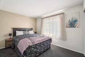 a bedroom with a bed and a window at Holiday in a paradise in Wanaka