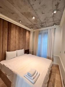 a bedroom with a bed with towels on it at AB Residences -Cihangir Luxury Sapphire Apartment in Istanbul