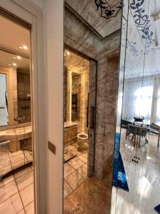 a bathroom with a shower and a glass door at AB Residences -Cihangir Luxury Sapphire Apartment in Istanbul