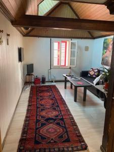 a living room with a rug on the floor at Sonderbar Home in Schwyz