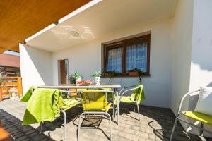 a patio with a table and chairs on a patio at Emilia domki U Przyjaciół in Żarnowska +7 photos