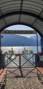 a pier with a sign that reads new zealonne at Residence Laguna Beach in Pianello Del Lario