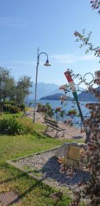 a park with a bench and a street light at Residence Laguna Beach in Pianello Del Lario