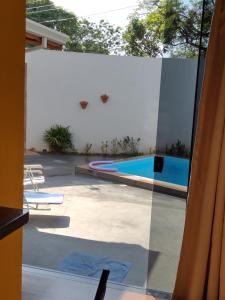 a view of a swimming pool through a window at Casa Mariano in Brotas