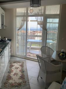 a kitchen with a large window with a view of the ocean at Mudanya Falez Evleri. in Mudanya