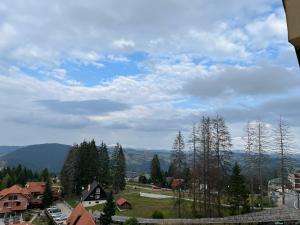 Blick auf eine Stadt mit Bäumen und Bergen in der Unterkunft Apartman Vuk Zlatar in Brdo