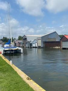 a boat is docked in a marina with houses and water at 4 bedroom apartment on 75 acre farm in Tillsonburg