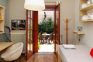 a bedroom with a door open to a patio with a table at Olga's Cozy home in Monemvasia