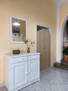 a white cabinet in a room with a mirror at Villa Luigi in Torre Pali +37 photos
