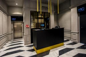 a lobby with a reception desk and a checkered floor at K40 Boutique Apartment in the City Center in Budapest +30 photos
