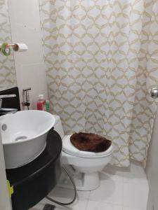 a bathroom with a toilet and a sink at Homey Studio at Stamford Mckinley hill few walk to Venice Piazza in Manila