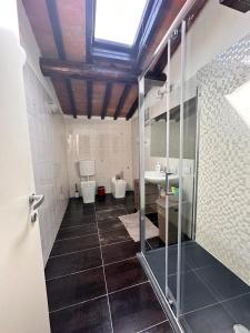 a bathroom with a shower and a toilet and a sink at Karivi - Poma in Florence