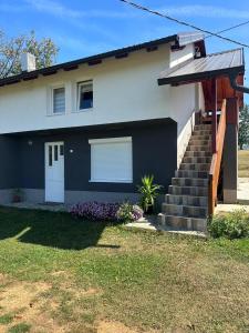 a blue and white house with a porch and stairs at Seosko domaćinstvo Kastratović in Berane