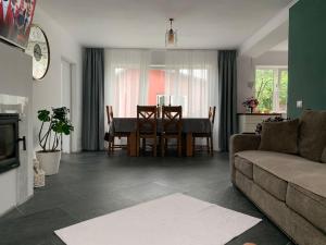 a living room with a table and a couch at Relaxing entire house with garden in Botoşani