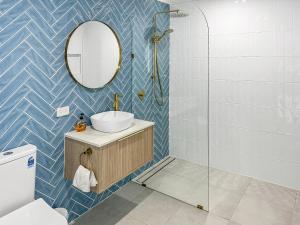 a bathroom with a sink and a mirror at Paradise Palms Tangalooma in Tangalooma