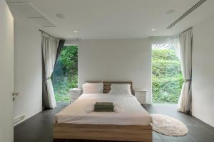 a bedroom with a bed and a large window at Cozy 5BR Villa Stunning SeaViews in Kamala Beach +63 photos