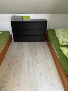 a room with two twin beds and a dresser at Pokoje in Duszniki Zdrój