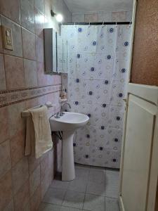 a bathroom with a sink and a shower at La Casona de la tía in La Consulta