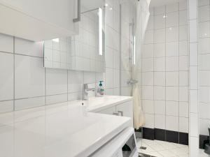 un bagno bianco con lavandino e doccia di Beautiful Apartment In The Heart Of Aalborg ad Aalborg Altre 19 foto