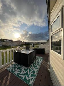 a balcony with a coffee table on a deck at Pebble Ridge hoilday home in Northam