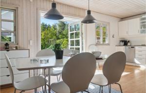 a kitchen and dining room with a table and chairs at Stunning Home In Rdby With Wifi in Rødby