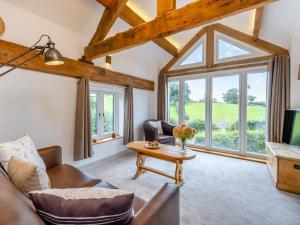 a living room with a couch and a table at The Ash Loft in Audlem