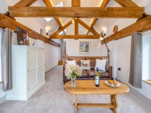 a living room with a couch and a table at The Ash Loft in Audlem