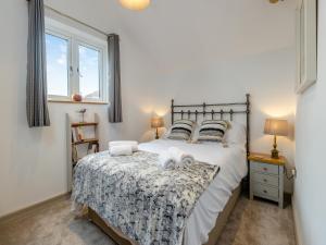 a bedroom with a bed with two dogs on it at The Ash Loft in Audlem