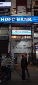 un par de personas caminando en frente de un edificio en Hotel Shiva Krishna(Unit of Nandan Udyam Pvt Ltd), en Patna