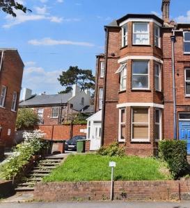 a brick house with a staircase in front of it at Central Exeter's Perfect 2 BR Flat in Exeter